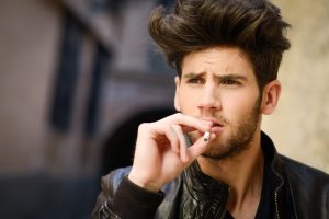 Young Man Smoking A Cigarette